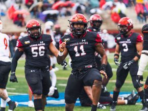 Eric Jackson stands on the football field during a game with his teammates