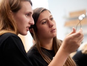 Two students look at experiment in a science lab