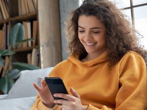 Student accessing TimelyCare service on her mobile phone from her couch