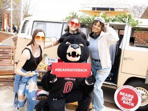 Joe Bear and students at Bears Give back
