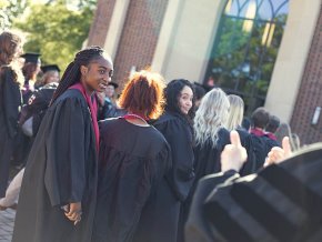 Students gathering in caps and gowns