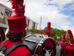 Marching band along the Mall with Washington Monument in background