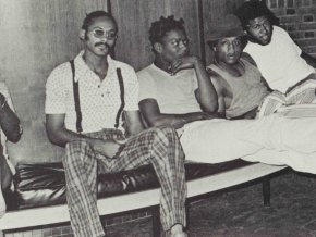 Five male students sit together in a 1974 black and white photo