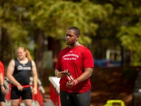 Ellis Horton wraps his wrist at an outdoor meet before a track and field event