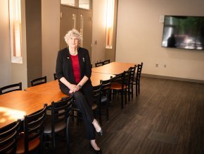 Kate Esch leans on a table in the space designated for the new food pantry