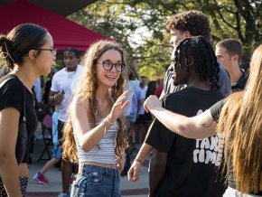 Students greeting each other at the 2024 president's cookout