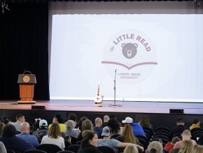 Stage with LR podium and The Little Read logo projected in the center of a white screen