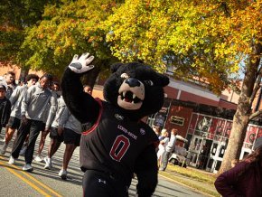 Joe Bear waves to the crowd at the homecoming parade