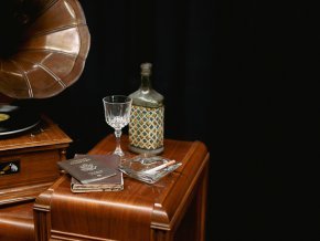 Stage props for Cabaret--gramophone, decanter, glass, passport, ashtray on a table