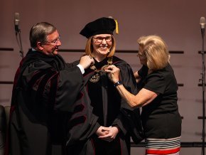 Mickey Payseur and Madeleine Dassow place the presidential medallion on Summer McGee