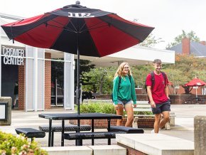 Students walk outside the Cromer Center.