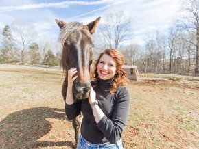 Carly York author photo with her horse