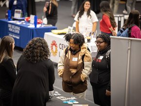 Students visit tables at a career fair in Hickory