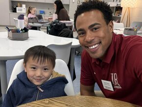 A LR education major poses for photo in literacy center with student