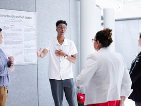 Student explaining a display at 2026 SOURCE Day.