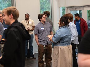 Students and employers talking to each other at a reception