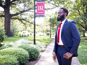 Dominic Jackson with the quad and an LR banner in background