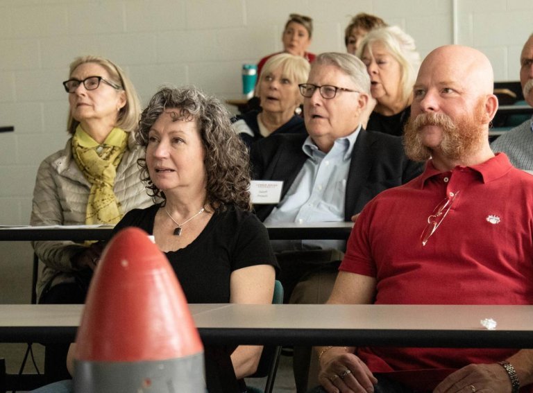 Alumni sit in classroom during back to school alumni weekend event