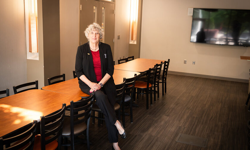 Kate Esch leans on a table in the space designated for the new food pantry