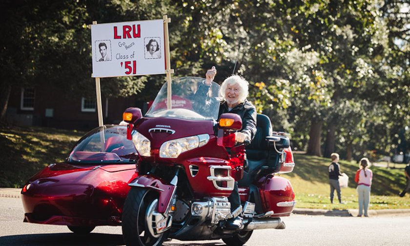 Joe Shumate, with Kathleen Tucker in the sidecar, rides a red Honda Gold Wing in the 2025 Homecoming Parade