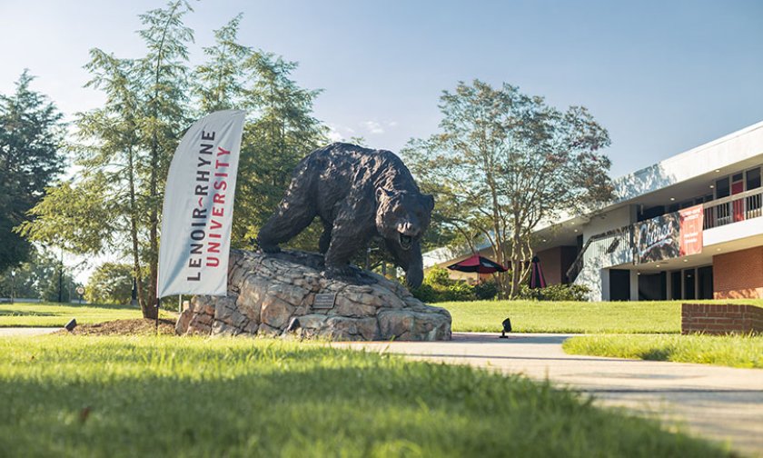 The Charge statue next to a Lenoir Rhyne Banner and Cromer Center in the background
