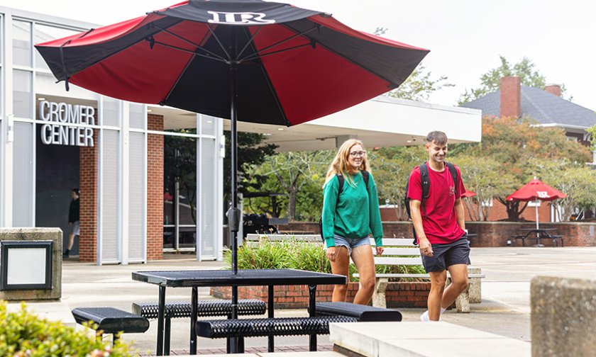 Students walk outside the Cromer Center.