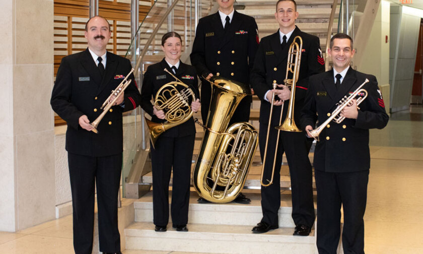 U.S. Naval Band Wind Ensemble poses with their instruments
