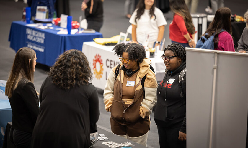 Students visit tables at a career fair in Hickory