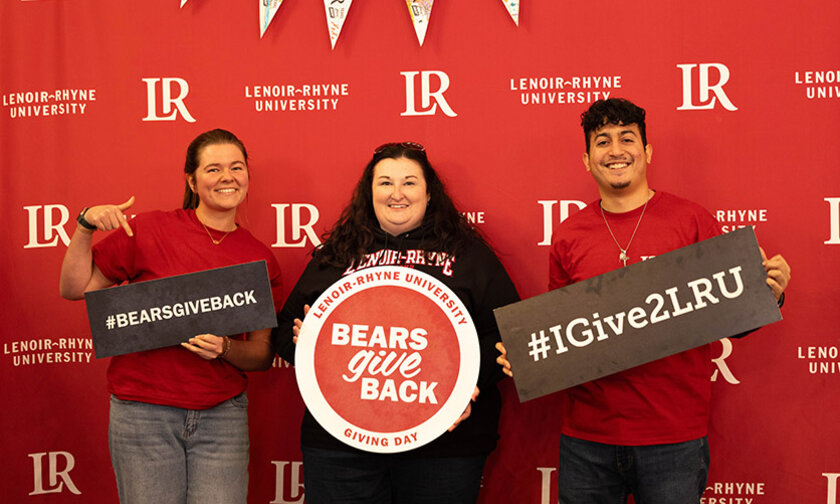 Ivy Throneburg, Stephanie Roberts, Diego Sanjuan holding BGB signs