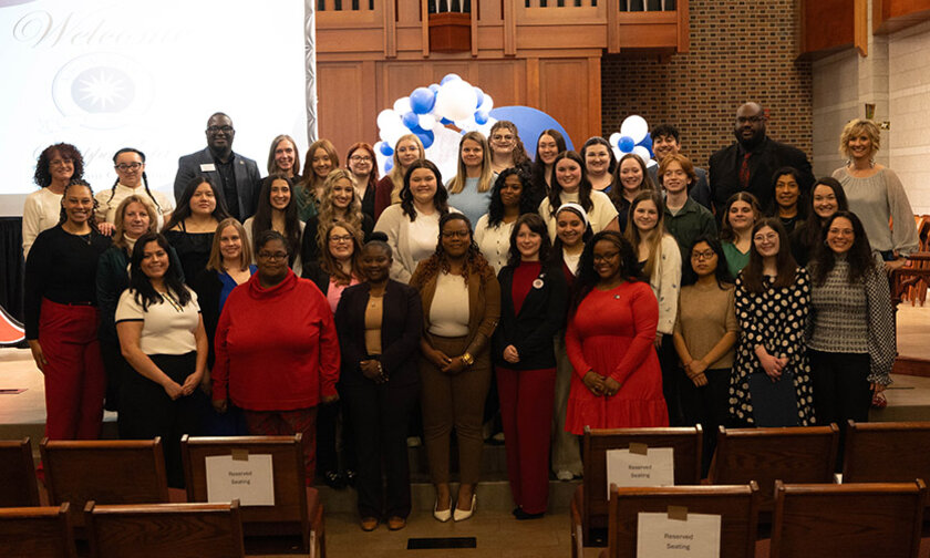 The full class of 2026 Tri-Alpha inductees at the front of Grace Chapel