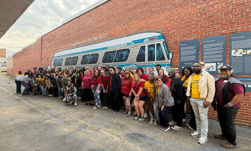 Lenoir-Rhyne and Southeast Louisiana choirs pose in front of a Freedom Rides bus mural