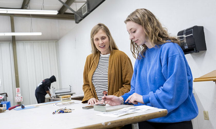 Claire Pope works with a student in the LR art studios