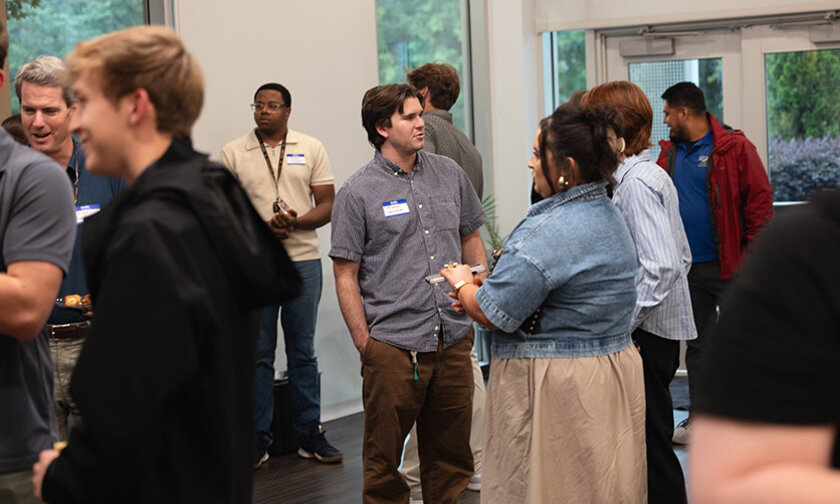 Students and employers talking to each other at a reception
