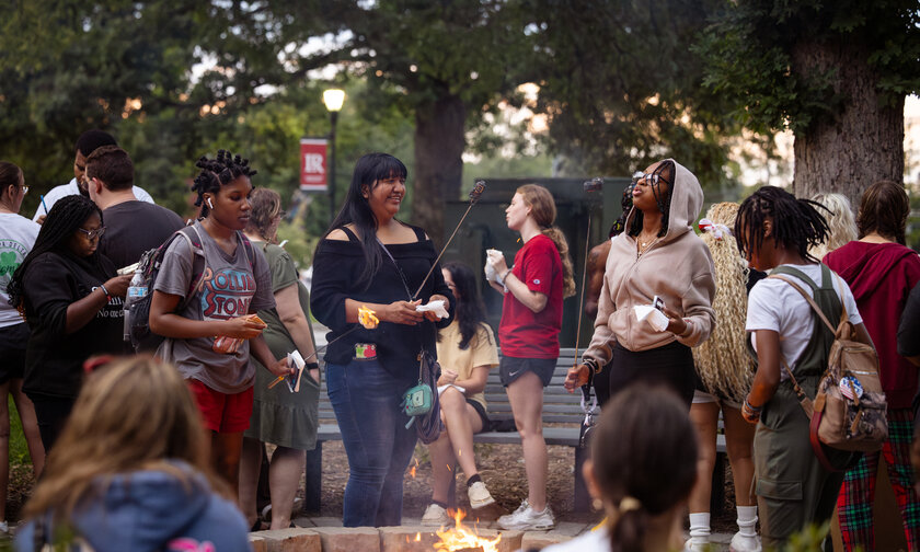 Students gather around a fire pit to socialize during Welcome Weekend