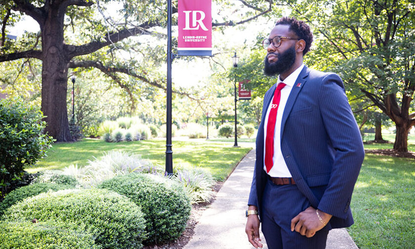 Dominic Jackson with the quad and an LR banner in background