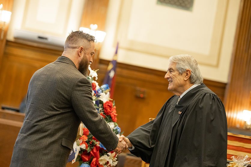 Judge Pope congratulating a graduate
