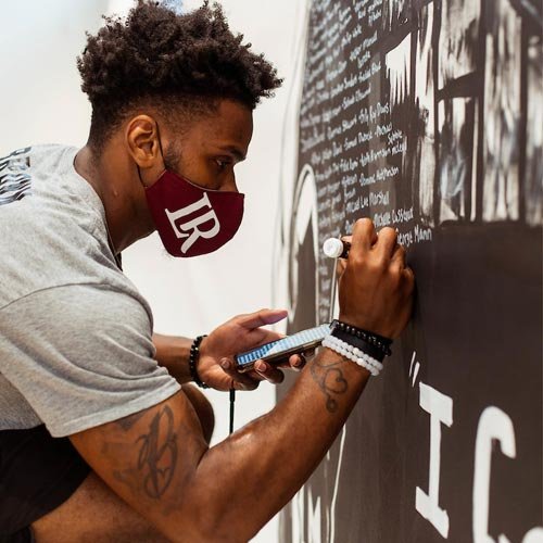 Amari Brown painting Black Lives Matter mural