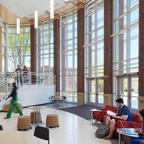 Students studying at tables in George Hall Atrium