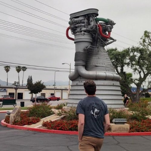 Caleb Knight with rocket engine monument