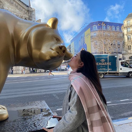 Kenzie Foyle with a bear statue in Paris