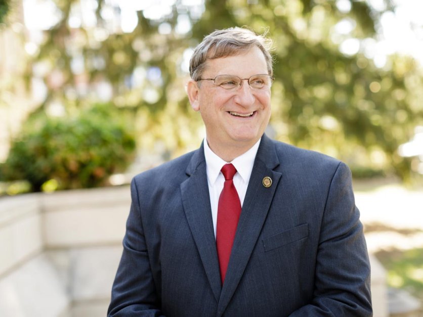 LRU President Dr Fred K Whitt smiling while looking off camera