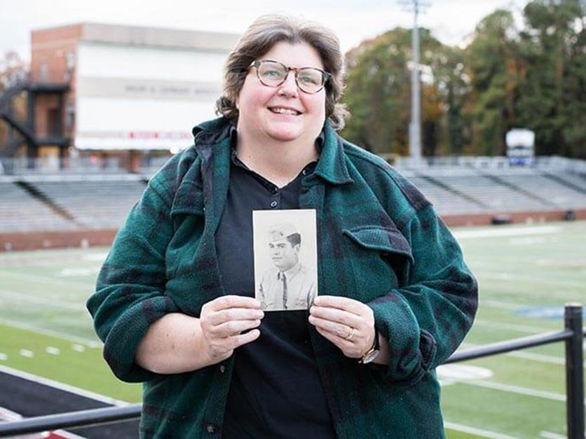 LR professor Janet Painter holding a picture of her dad and LR legend Hanley Painter in uniform during World War II.