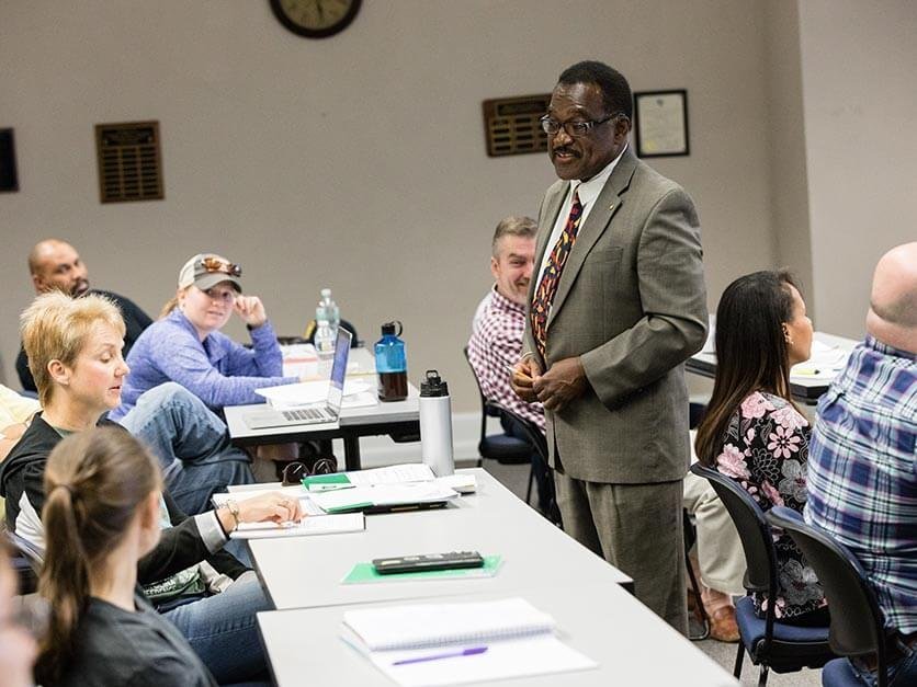 LTSS professor talking to students in a classroom.