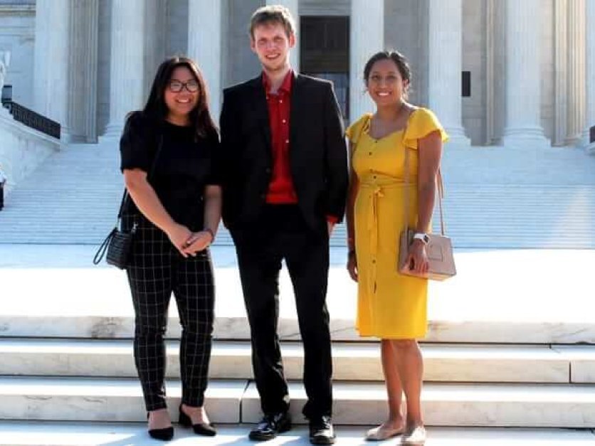 Three student interns in front of the supreme court building