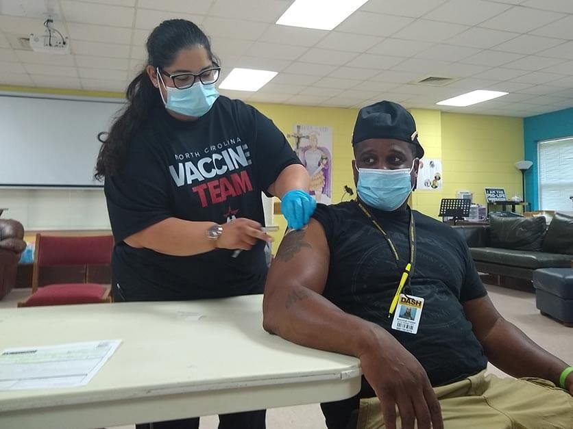 A man receives a vaccination.