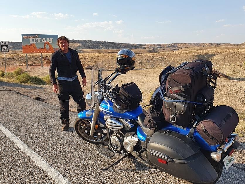 Bobby Jackson with his motorcycle on the side of the road entering Utah.