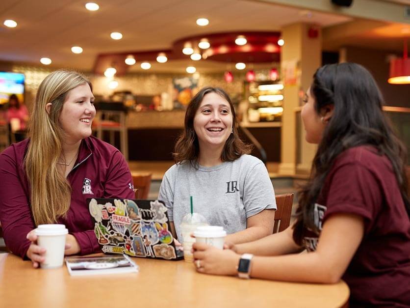 High school students eating lunch in the LR cafeteria.