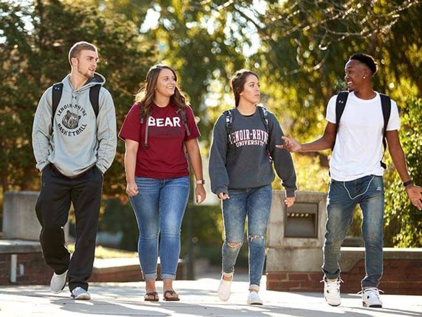 Four LR students walking across campus