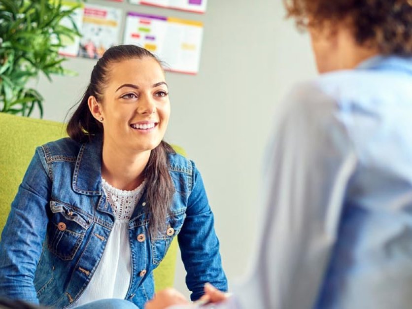 A student talking to a counselor in an office