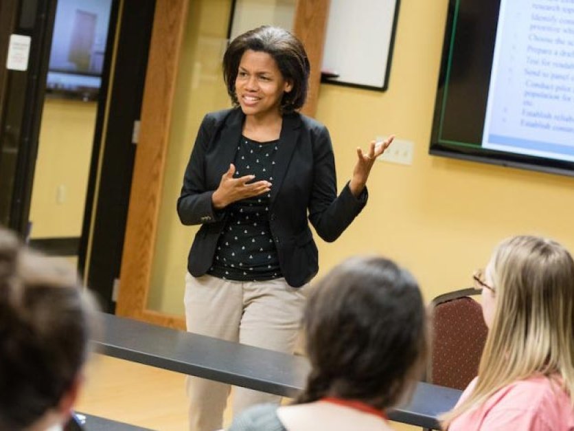 Professor lectures to students in front of classrrom